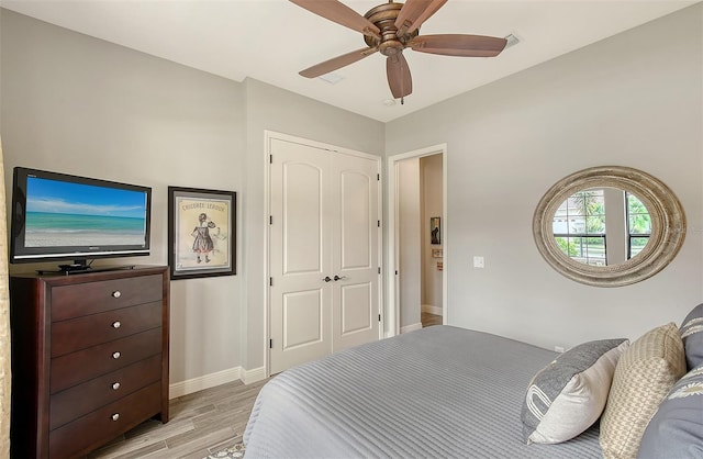 bedroom featuring ceiling fan, a closet, and light hardwood / wood-style floors