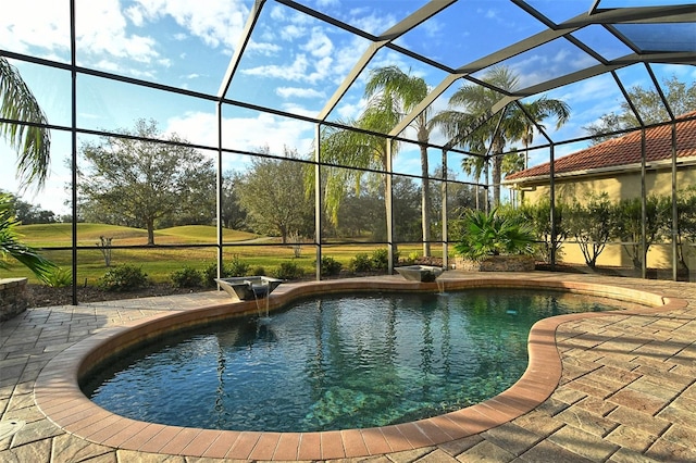 view of pool with a patio area and glass enclosure