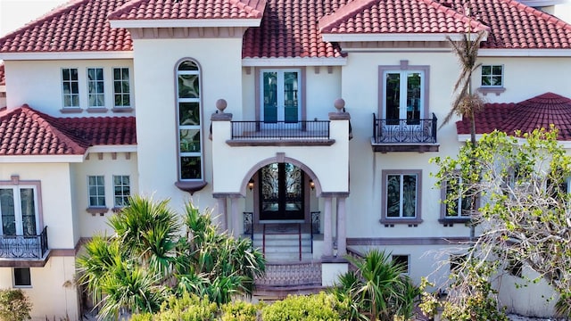 mediterranean / spanish-style home with french doors