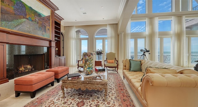 living room with built in features and ornamental molding