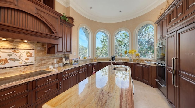 kitchen featuring black electric stovetop, decorative backsplash, sink, light stone countertops, and wall chimney exhaust hood