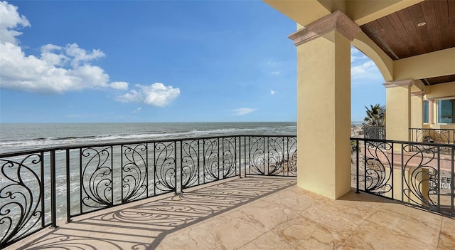 balcony with a beach view and a water view