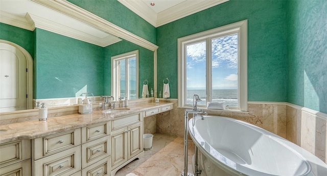 bathroom with a tub to relax in, vanity, crown molding, and a water view