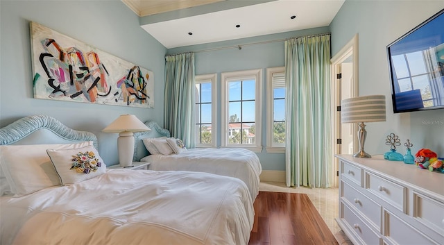 bedroom featuring crown molding and hardwood / wood-style flooring