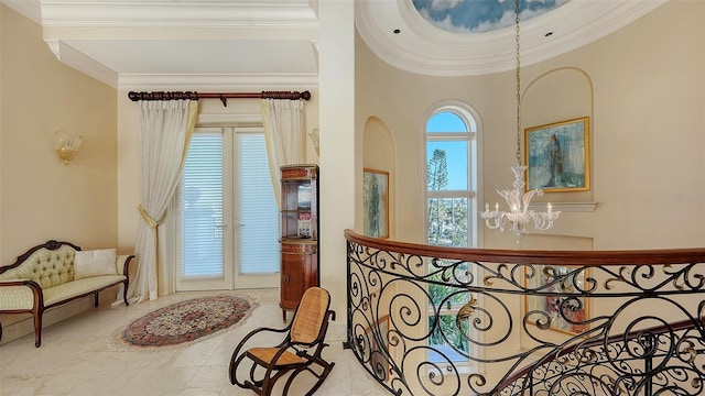 interior space featuring ornamental molding and a notable chandelier