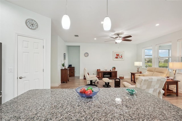 dining area with ceiling fan and light hardwood / wood-style flooring