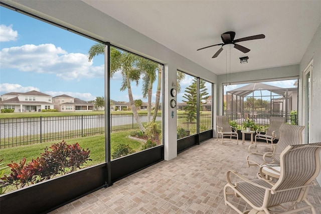 sunroom featuring ceiling fan