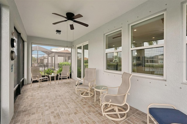 sunroom / solarium with ceiling fan