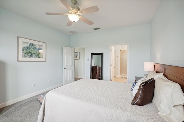 carpeted bedroom with ceiling fan and ensuite bath