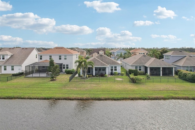 view of front of property featuring a lanai, a front yard, and a water view