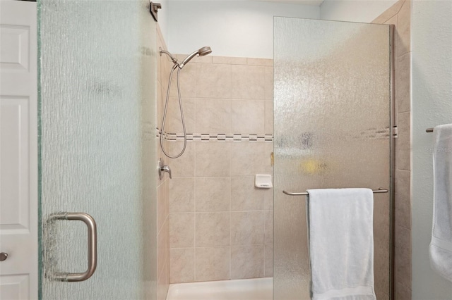 bathroom with a shower with shower door