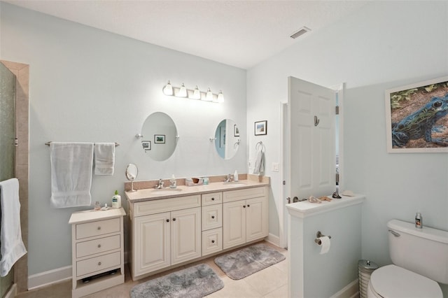 bathroom with walk in shower, vanity, tile patterned flooring, and toilet