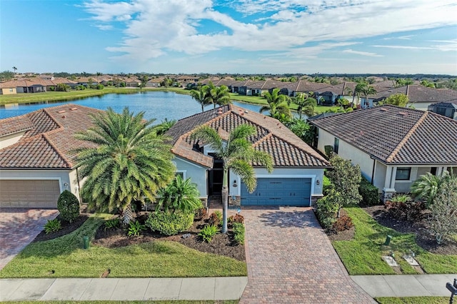 exterior space featuring a garage and a water view