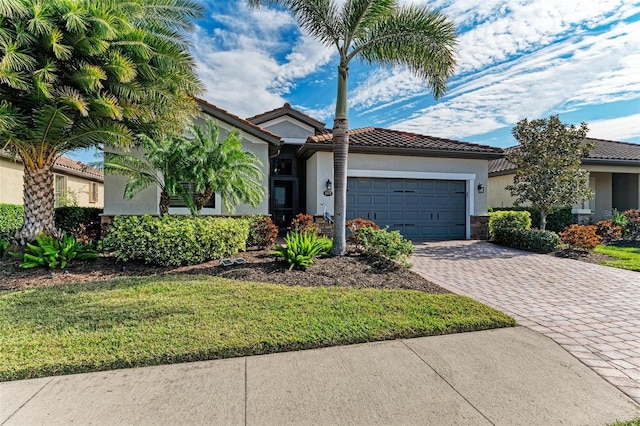 view of front of home with a front yard and a garage