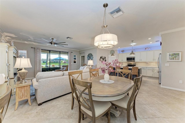 tiled dining room featuring ceiling fan and ornamental molding