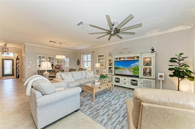 tiled living room with ornamental molding and ceiling fan