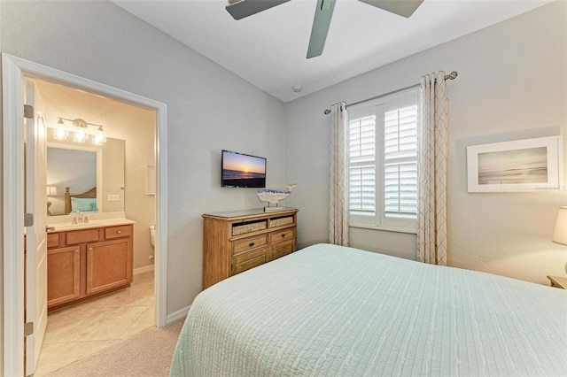 bedroom with sink, ensuite bath, ceiling fan, and light colored carpet