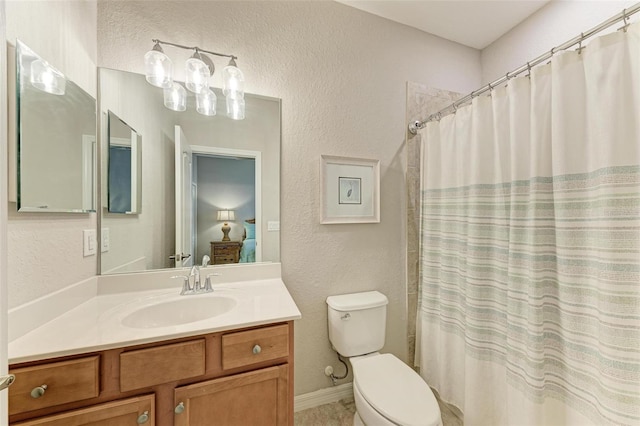 bathroom with curtained shower, vanity, and toilet