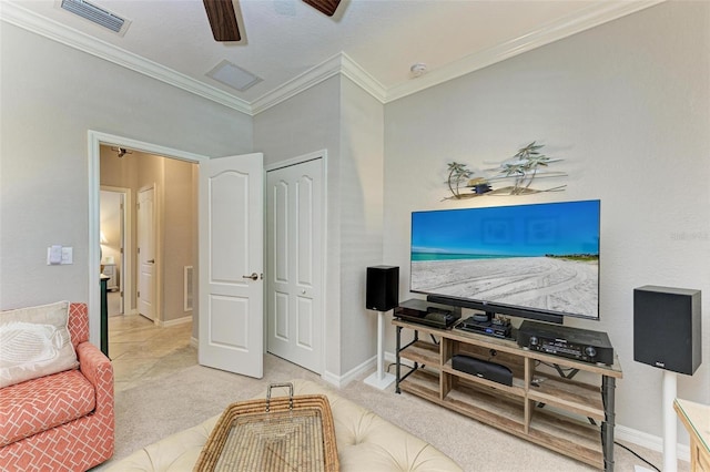 living room featuring ceiling fan, ornamental molding, and light colored carpet