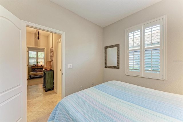 tiled bedroom with multiple windows