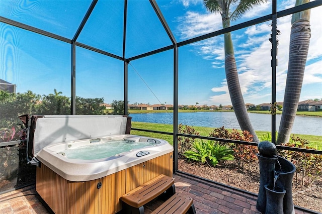 sunroom / solarium featuring a jacuzzi and a water view