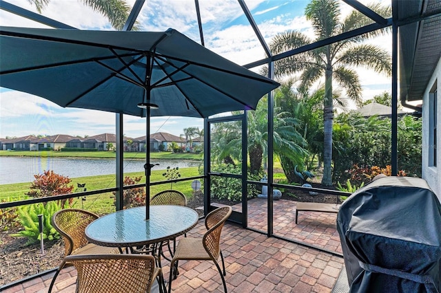 sunroom / solarium featuring a water view