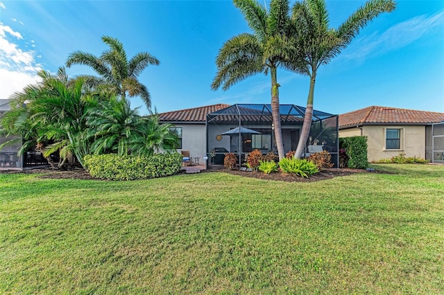 back of property with a lanai and a yard