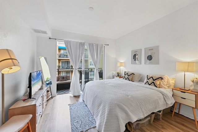 bedroom with light hardwood / wood-style flooring and access to outside