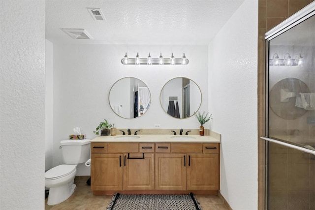 bathroom featuring a textured ceiling, toilet, an enclosed shower, and tile patterned flooring