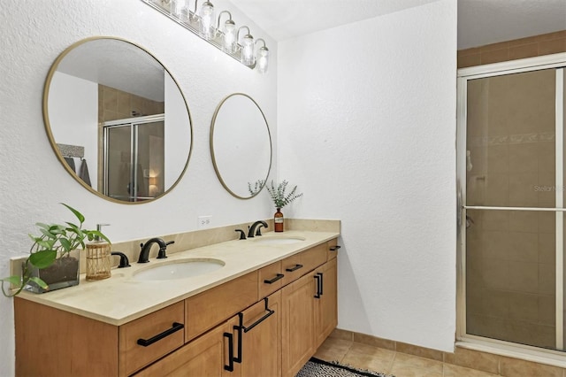 bathroom with walk in shower, tile patterned floors, and vanity