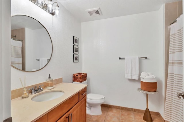 bathroom featuring toilet, vanity, tile patterned flooring, and curtained shower