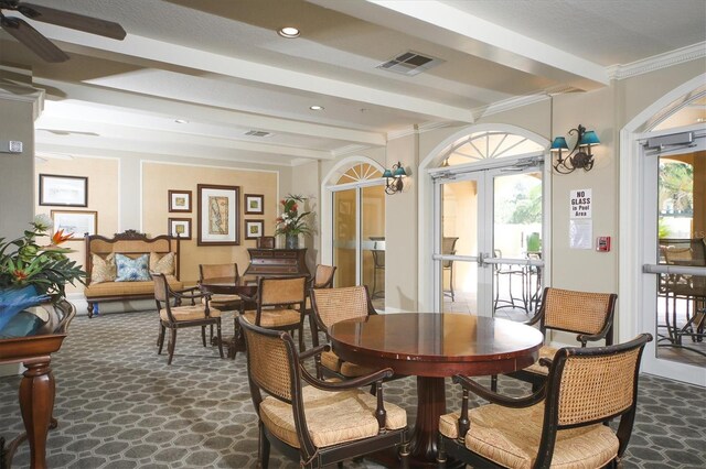 dining space featuring ceiling fan, french doors, beamed ceiling, and crown molding