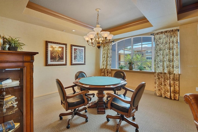 dining area featuring a chandelier, crown molding, light colored carpet, and a raised ceiling