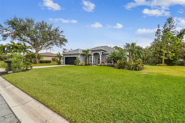 view of front facade with a front yard and a garage