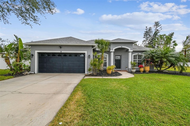 single story home with a front yard and a garage