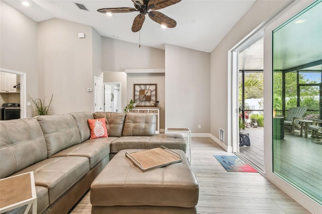 living room featuring ceiling fan, lofted ceiling, and light hardwood / wood-style floors