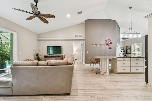 living room featuring ceiling fan and vaulted ceiling