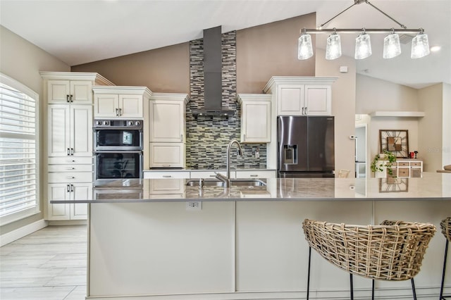 kitchen featuring decorative light fixtures, white cabinetry, stainless steel appliances, sink, and backsplash