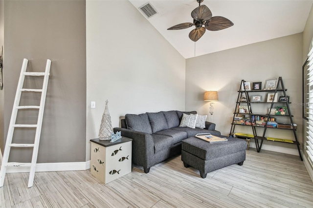 living room with ceiling fan, vaulted ceiling, and light hardwood / wood-style floors