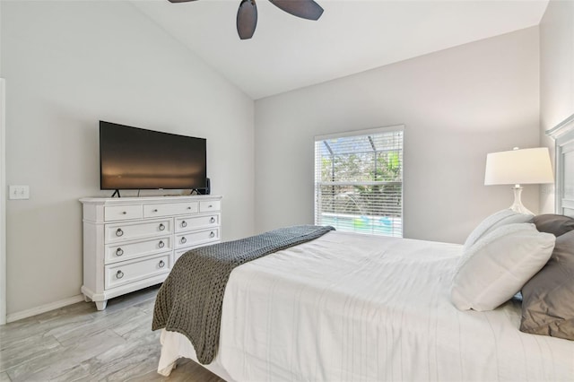 bedroom featuring ceiling fan, light hardwood / wood-style flooring, and vaulted ceiling