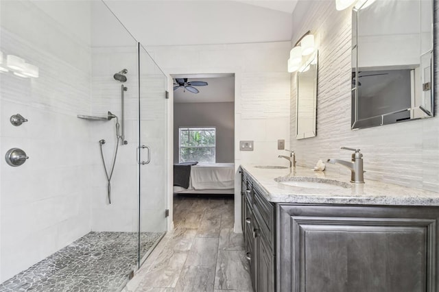 bathroom with an enclosed shower, vanity, tasteful backsplash, vaulted ceiling, and ceiling fan