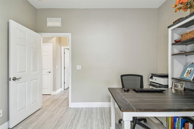 office with light hardwood / wood-style floors