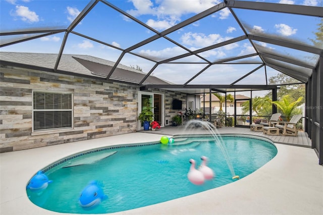 view of swimming pool with pool water feature, a patio, and a lanai