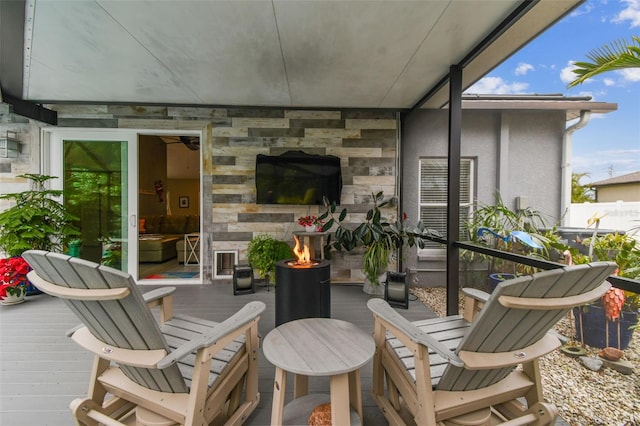 view of patio / terrace featuring a deck and a fire pit