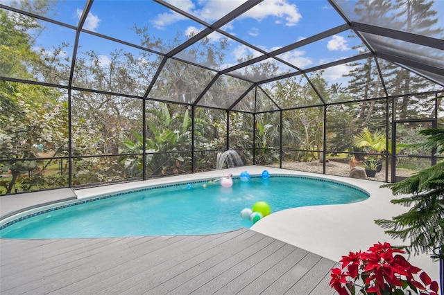 view of pool with glass enclosure