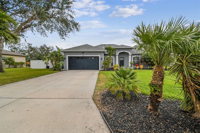 view of front of property with a front yard and a garage