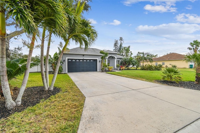 view of front of home with a front yard and a garage