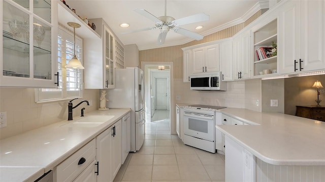 kitchen with white appliances, white cabinets, sink, decorative light fixtures, and light tile patterned flooring