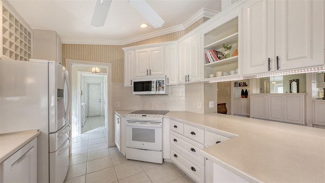 kitchen featuring white appliances, ceiling fan, ornamental molding, light tile patterned flooring, and white cabinetry