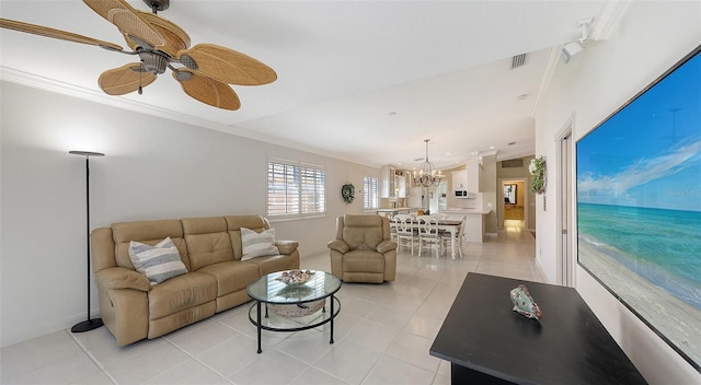 living room featuring ceiling fan with notable chandelier, light tile patterned floors, and crown molding